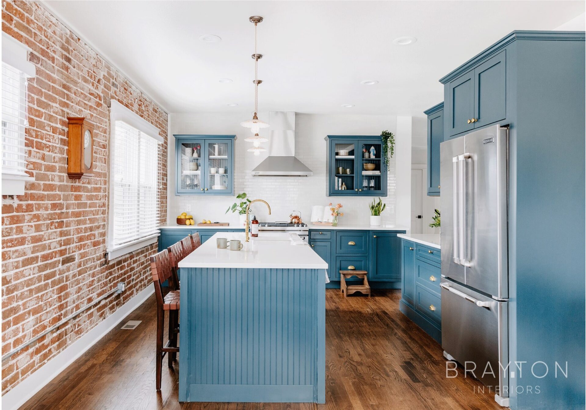 Exposed brick in historic Denver bungalow home renovation. Handcrafted, thoughtful details, refinished hardwood floors, ceramic pendant lights and brass hardware throughout.