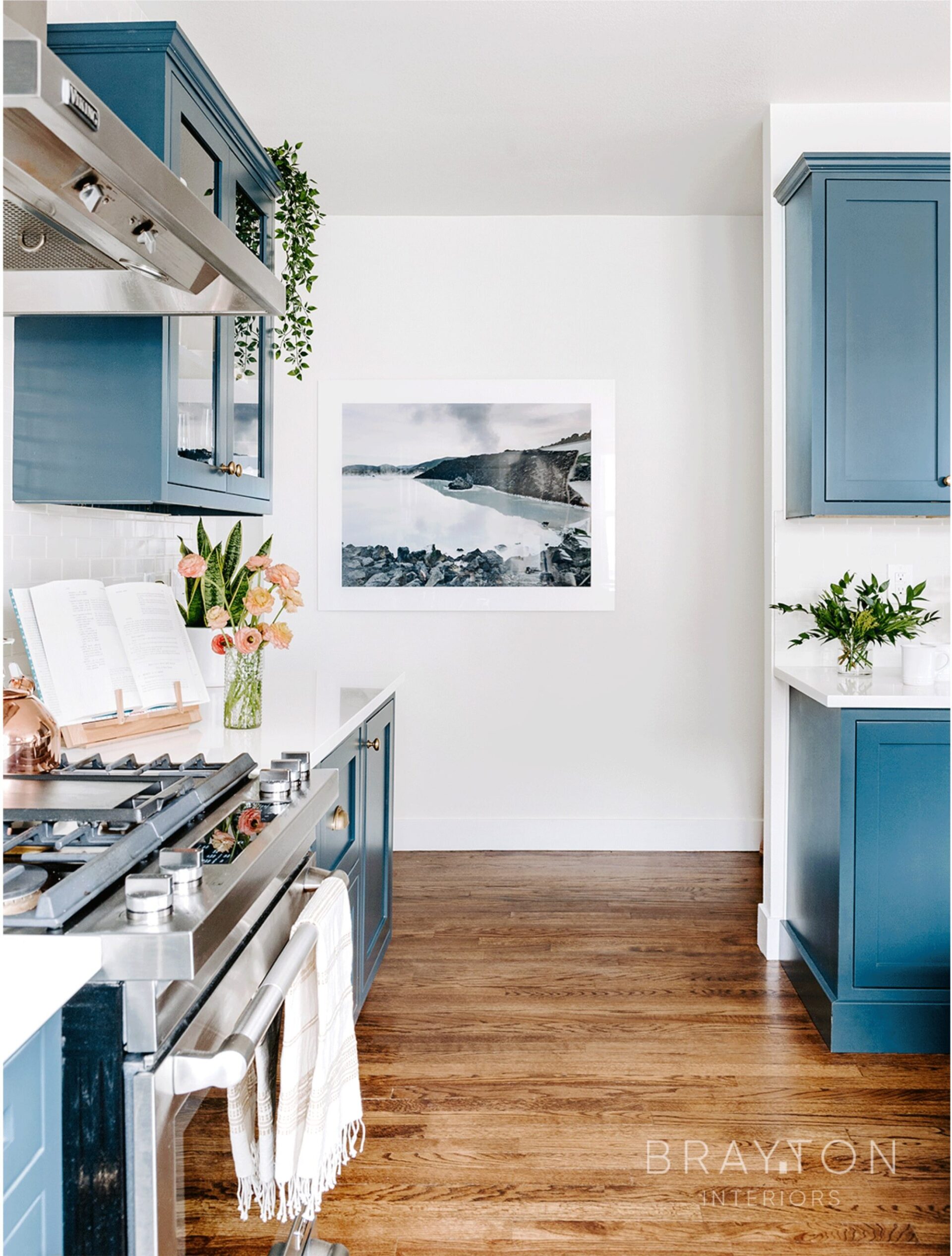 Custom color matched cabinetry (Benjamin Moore “Narragansett Green”) with original historic solid hardwood floors, with a custom framed art print in the background.