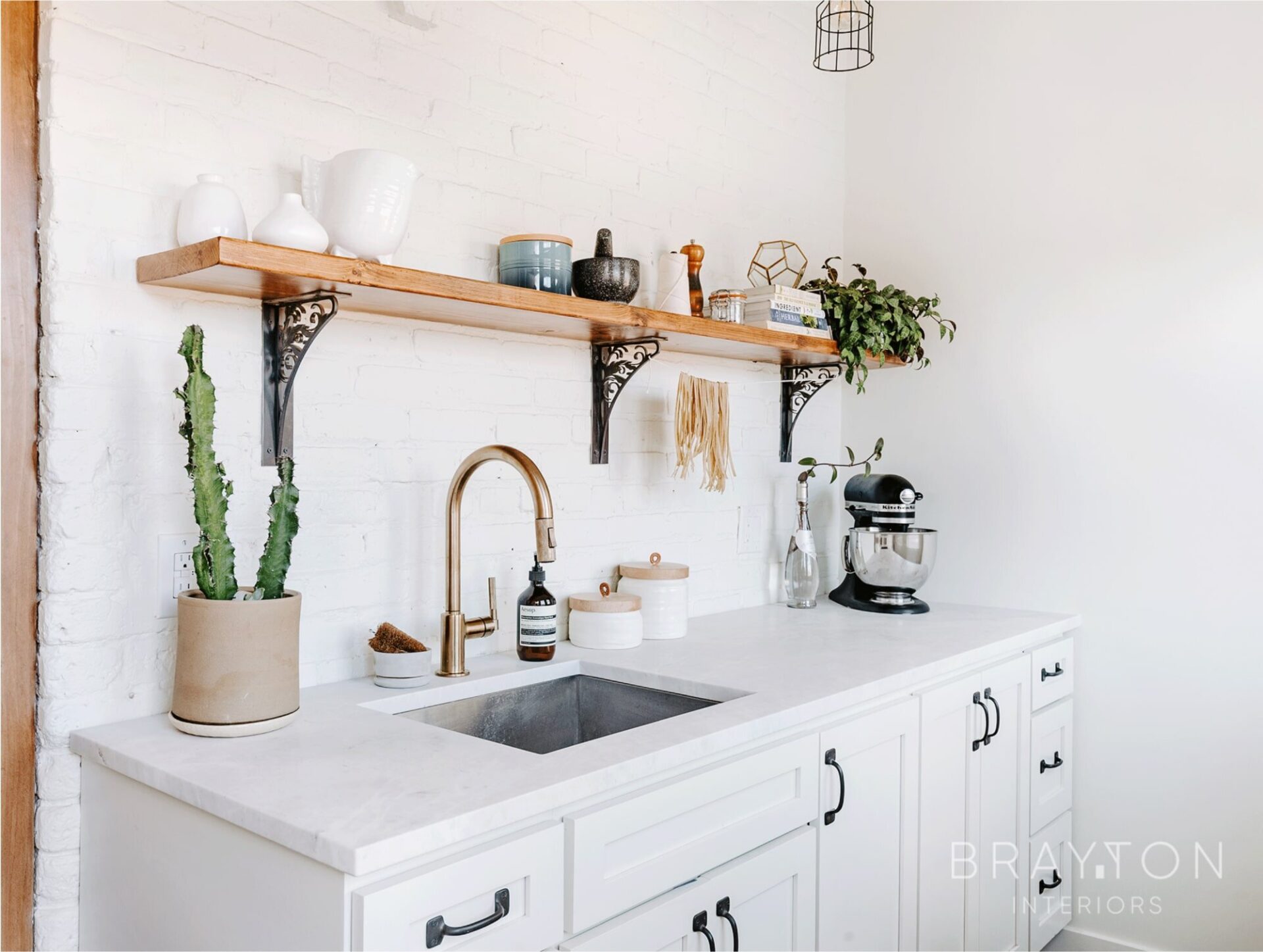 Real marble countertops, brass plumbing fixtures and slate flooring stay true to the original architecture in this historic Denver Highlands townhome.
